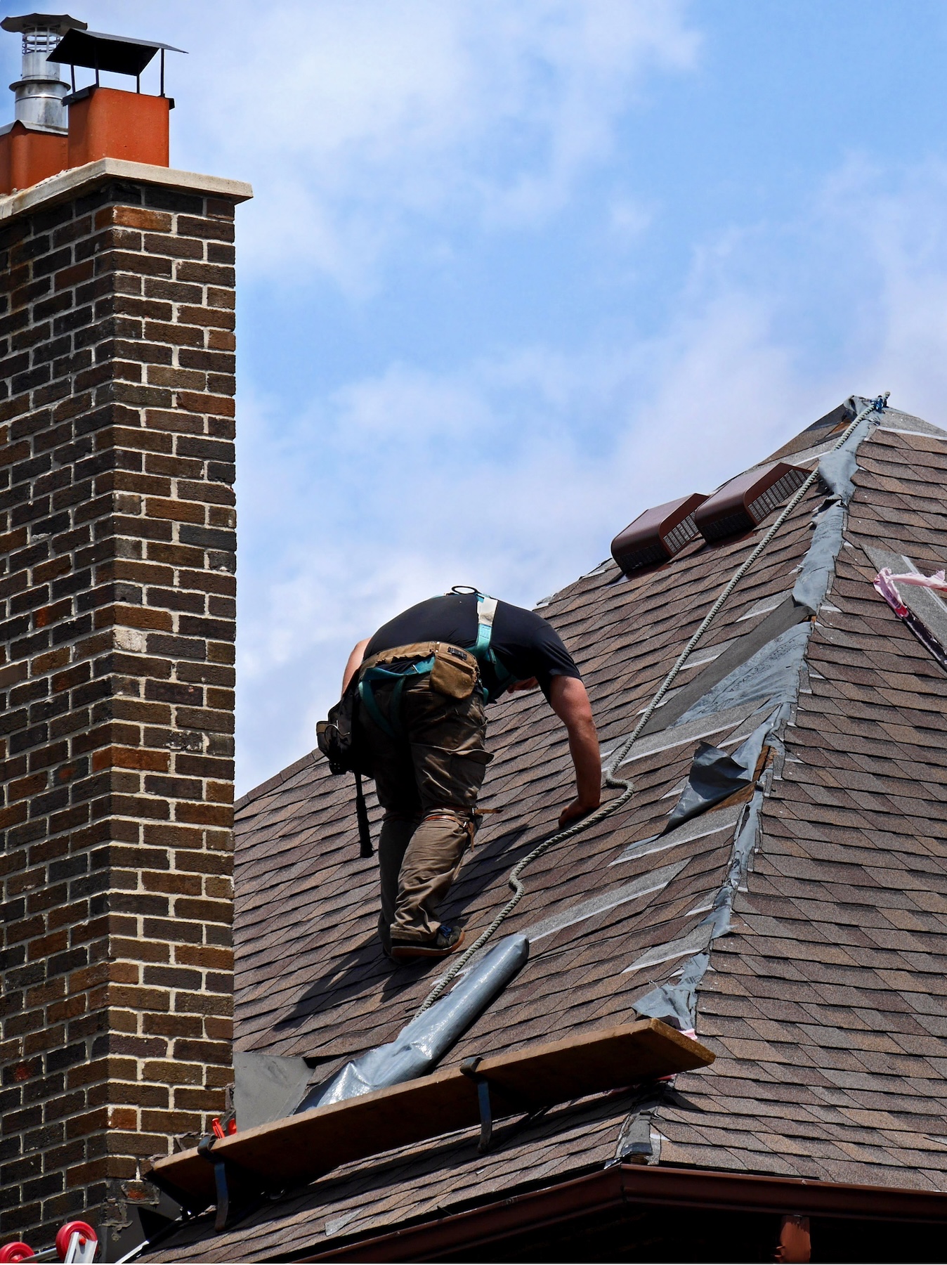man fixing damaged roof man fixing damaged roof
