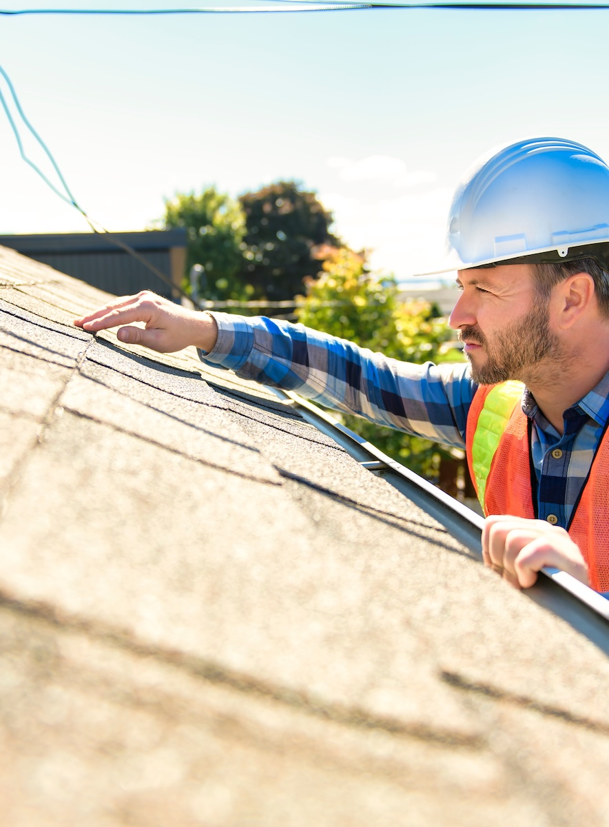 man examining roof man examining roof