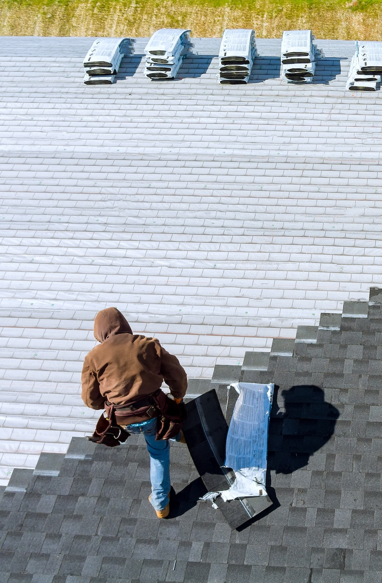 man installing roof