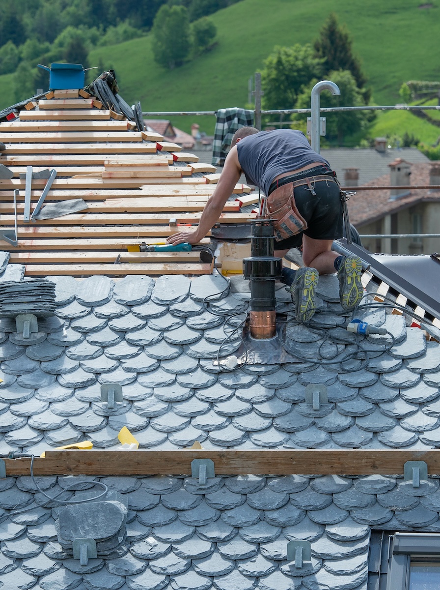 man installing slate roof man installing slate roof