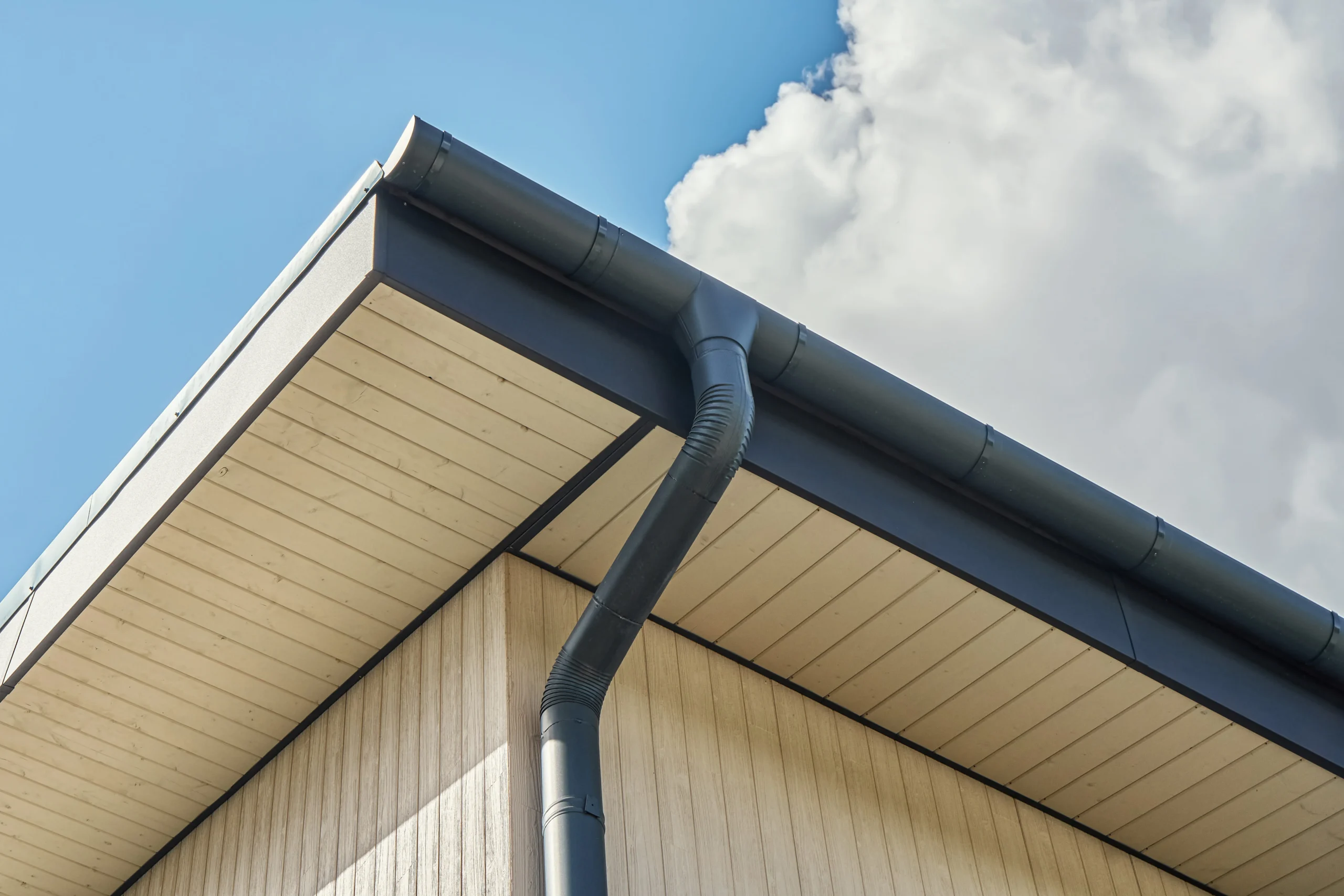 Contemporary grey metal rainwater downpipe installed Contemporary grey metal rainwater downpipe installed